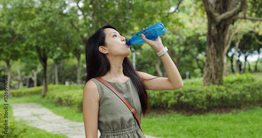 Woman drink of water at outdoor park Woman drink of water at outdoor park