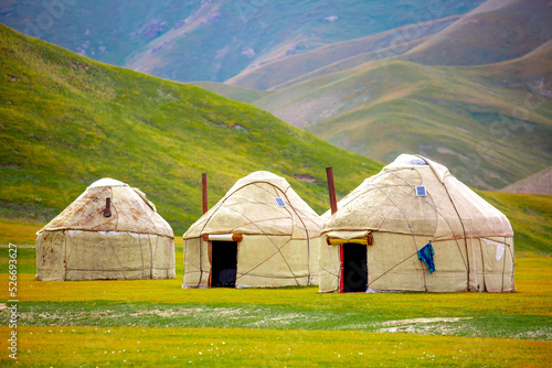 Yurt. National old house of the peoples of Kyrgyzstan and Asian countries. national housing. Yurts on the background of green meadows and highlands. Yurt camp for tourists.