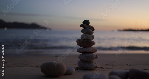 Zen stones on the beach in sunset time