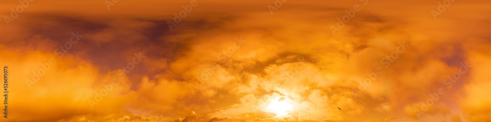 Golden glowing sunset sky panorama with Cumulus clouds. Hdr seamless spherical equirectangular 360 panorama. Sky dome or zenith for 3D visualization and sky replacement for aerial drone 360 panoramas.