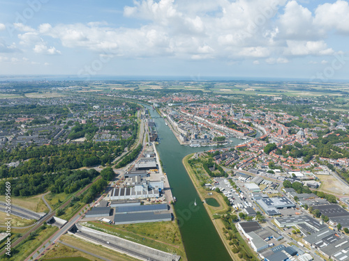 Middelburg is the capital city in the Dutch province of Zeeland on the former island Walcheren. urban skyline and city overview. Aerial drone overview of old city center canals and cultural heritage.