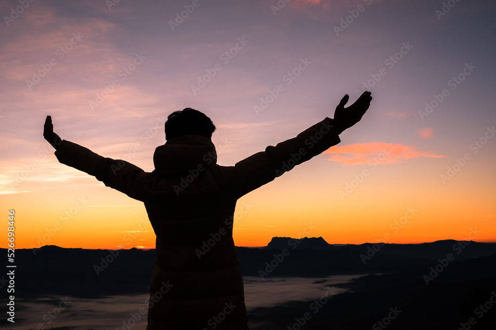 Silhouette of human person hands open palm up worship in sky sunset or sunset. Catholic adult man pray and hope on mountain. Christian religion concept background. fighting and victory for god
