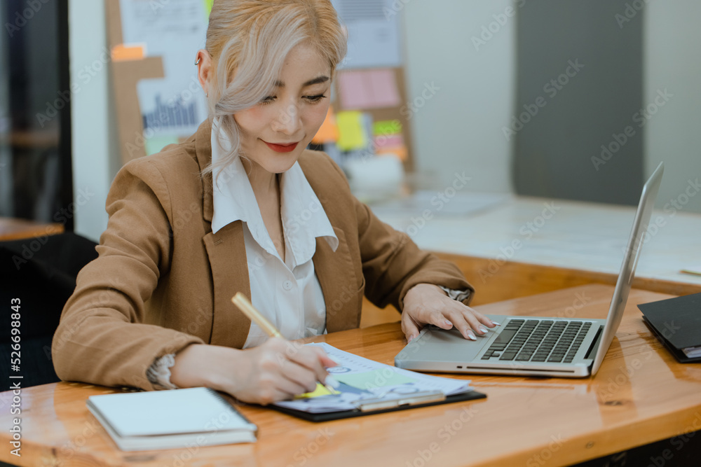 Businesswoman working with calculator and laptop computer at office workplace, finance marketing chart, Business digital technology and marketing concept. Businesswoman working with calculator and laptop computer at office workplace, finance marketing chart, Business digital technology and marketing concept.