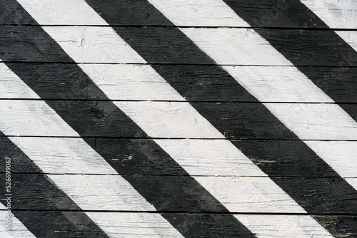 Boards are painted with black and white paint diagonally. Abstract background.