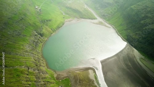 Aerial view of lagoon in Saksun village, Faroe Islands. Lagoon in beautiful green nature in Saksun. Mist faroese nature. High quality 4k footage. photo