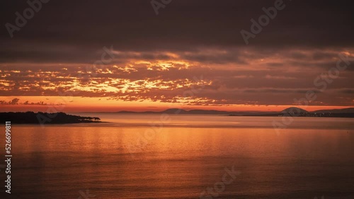 Day to night time lapse of Punta del Este beach at sunset with rippled ocean surface and Gorriti island in background, Uruguay photo