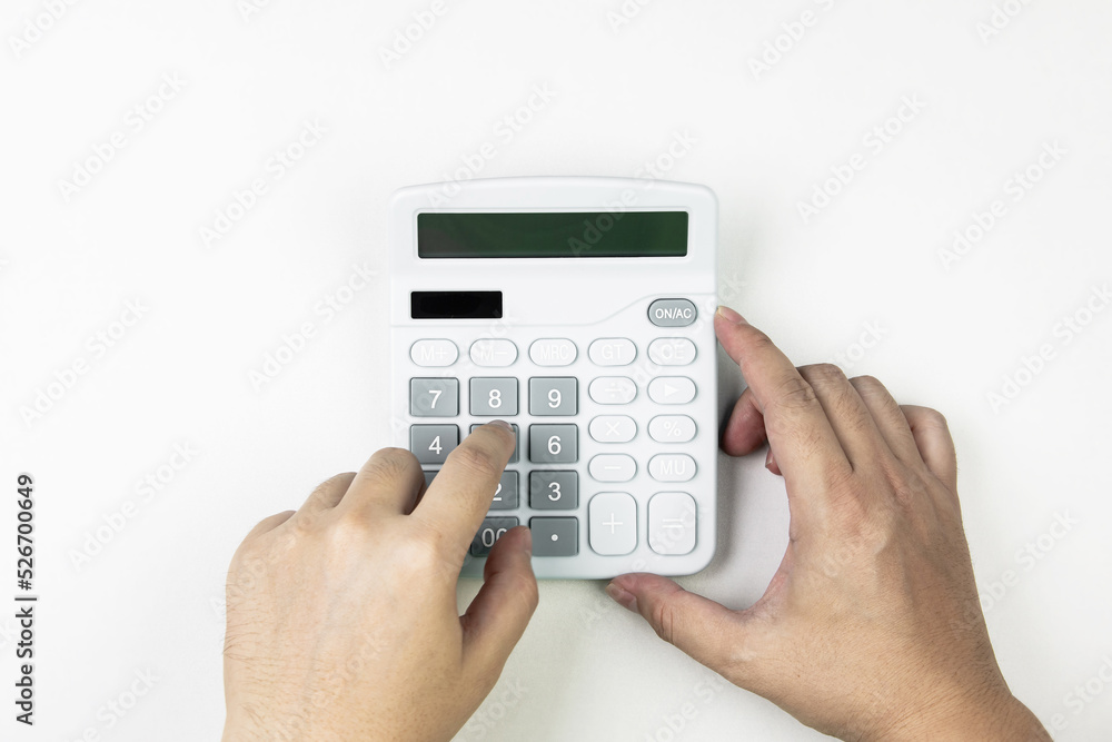 Top view of hand pressing calculator on white background. Top view of hand pressing calculator on white background.