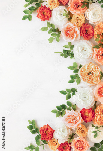 Autumn flowers composition made of beautiful roses and ranunculus flowers on light backdrop. Floristic decoration. Natural floral background.