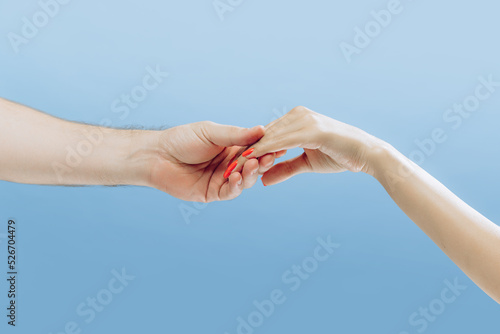 Touch. Graceful female hands gesturing isolated on blue background. Concept of relationship, feelings, community, care, support, symbolism, art