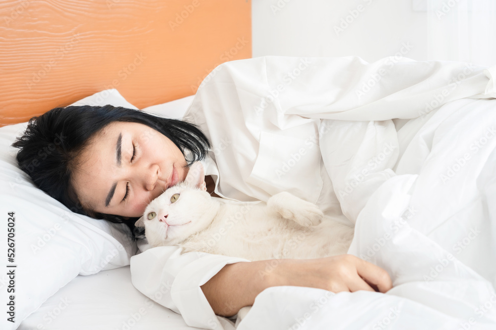 Asian woman sleeping with cat in bed Asian woman sleeping with cat in bed