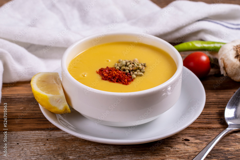 Lentil soup. Strained lentil soup on wooden background. Traditional Turkish cuisine. Close-up. local name suzme mercimek corbasi Lentil soup. Strained lentil soup on wooden background. Traditional Turkish cuisine. Close-up. local name suzme mercimek corbasi
