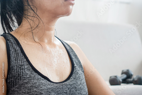 sweaty woman resting from exercise, tired from doing sport