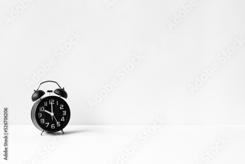 Black alarm clock retro style on white background. concept watch for add text message or art work design. pointer in 10 o'clock.