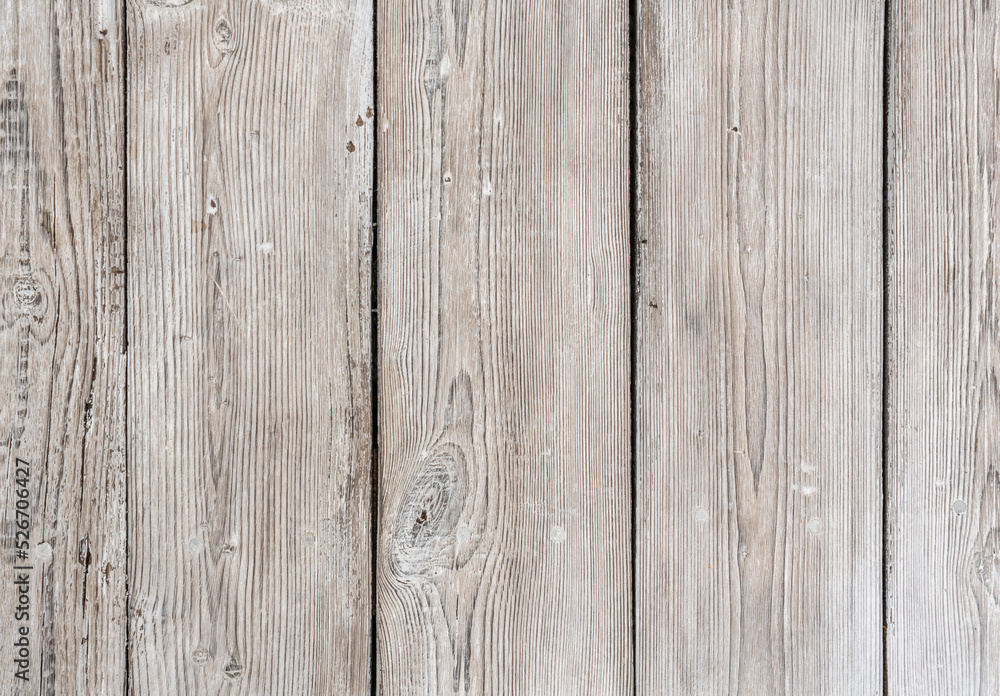 Old wooden boards arranged vertically are painted with white paint while preserving the texture of wood Old wooden boards arranged vertically are painted with white paint while preserving the texture of wood