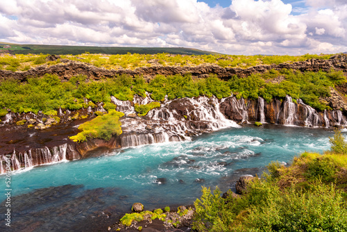 At 700 meters wide, the Hraunfossar waterfall apparently springs from a lava field, Iceland