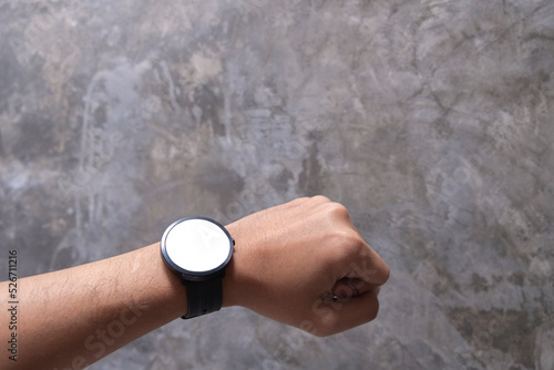 View of the smart watch screen on your hand with mockup on loft  background with clipping path