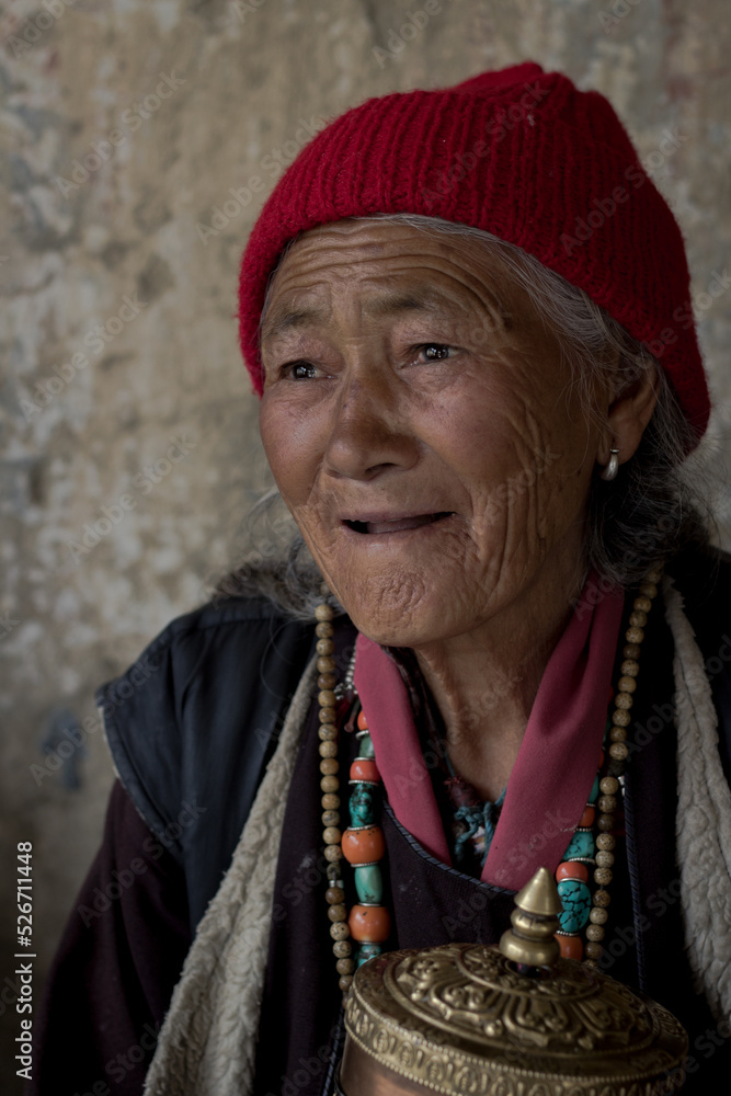 portrait of an old tibetian woman with wrinkles on her face in Tibet | Smiling old woman portrait of an old tibetian woman with wrinkles on her face in Tibet | Smiling old woman