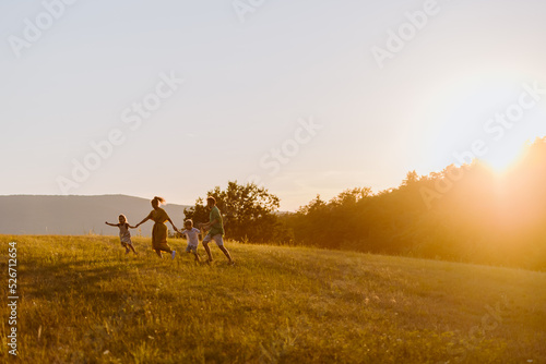 Happy young family spending time together outside in green nature. © Halfpoint