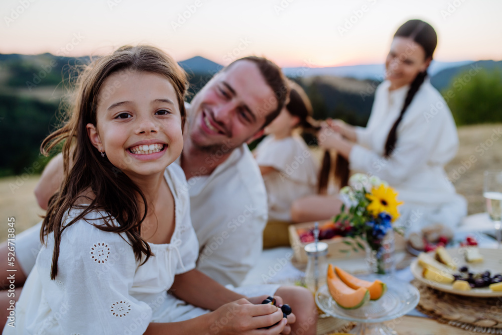 Happy family with children having picnic in park, parents with kids sitting eating healthy meals outdoors. Happy family with children having picnic in park, parents with kids sitting eating healthy meals outdoors.