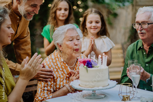 Photography Multi-generation family on outdoor summer garden party, celebrating birthday