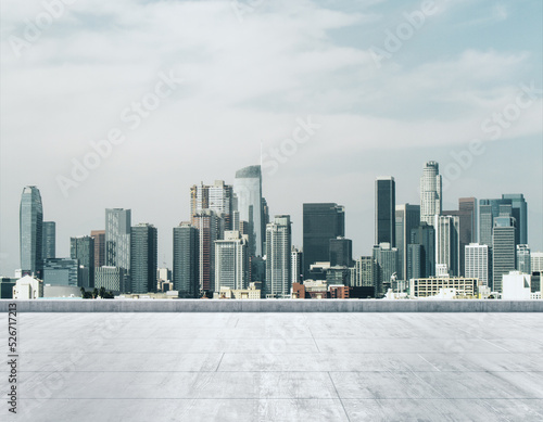 Empty concrete dirty rooftop on the background of a beautiful LA city skyline at morning, mock up © Pixels Hunter