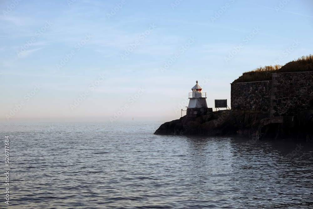 Lighthouse by the sea on a calm day