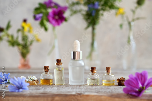 Selection of essential oils with frankincense, flowers and herbs