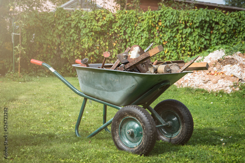 Pile of scrap metal in a barrow. Yard and garden cleaning