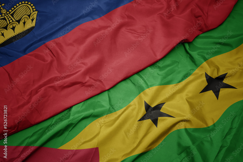 waving colorful flag of sao tome and principe and national flag of liechtenstein. waving colorful flag of sao tome and principe and national flag of liechtenstein.