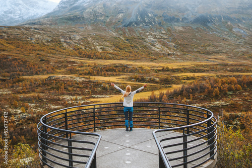 Autumn in Norway adventure travel outdoor woman raised hands on  Vegaskjelet viewpoint enjoying forest and mountains landscape healthy lifestyle tourist explore scandinavian nature photo