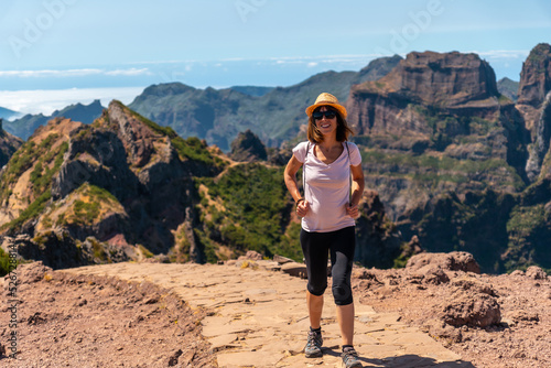 A tourist walking on the trekking trail at Pico do Arieiro in summer, Madeira. Portugal © unai