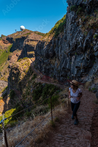 A young woman on the trail to the Ninho da Manta viewpoint on Pico do Arieiro, Madeira. Portugal