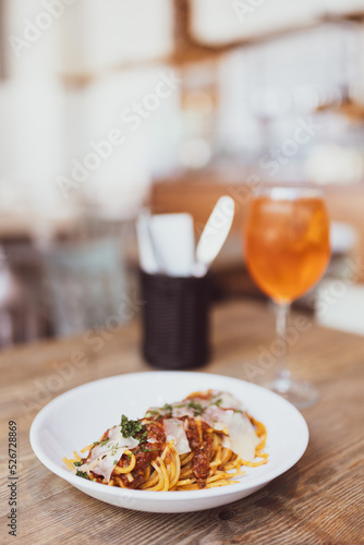 Traditional italian spaghetti bolognese and glass of Spritz Aperol. Concept of italian cuisine. Pasta with meat and tomato sauce