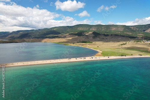Lake Baikal from the air in summer. View of the bay near the village of Kurma. Beautiful turquoise color of water, beach.