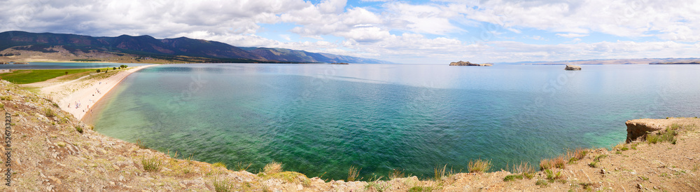 Lake Baikal in summer. View of the bay and islands near the village of Kurma. Panorama