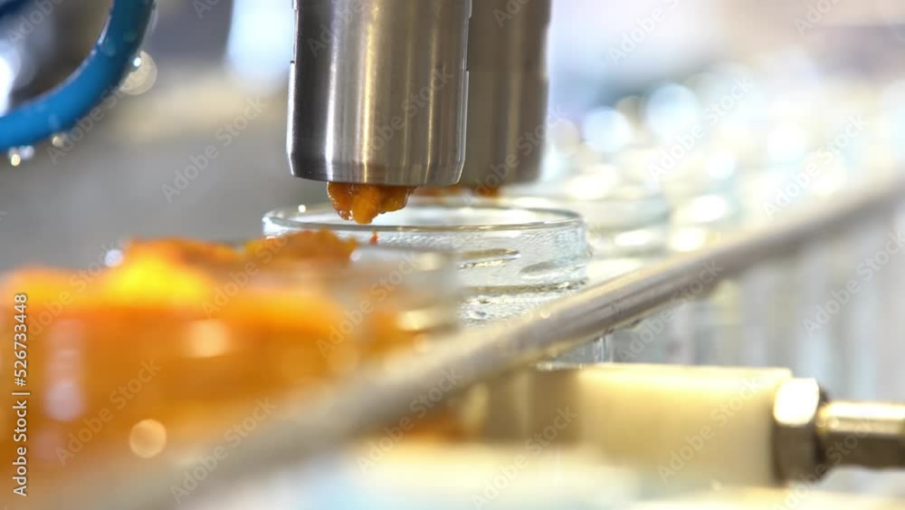Vegetable paste in automated production line. Bottling vegetables paste in glass jars. Modern factory. Automatic Line for Processing of Canned Vegetables. 