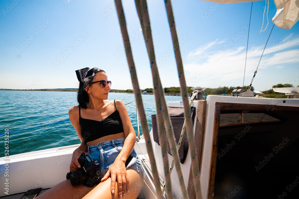 Woman resting on a yacht. Make photo
