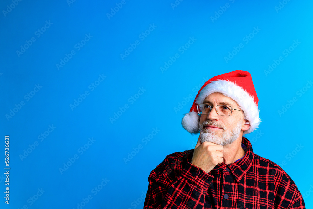 Handsome senior bearded man holding gift box and wish a Merry Christmas and a happy new year Handsome senior bearded man holding gift box and wish a Merry Christmas and a happy new year