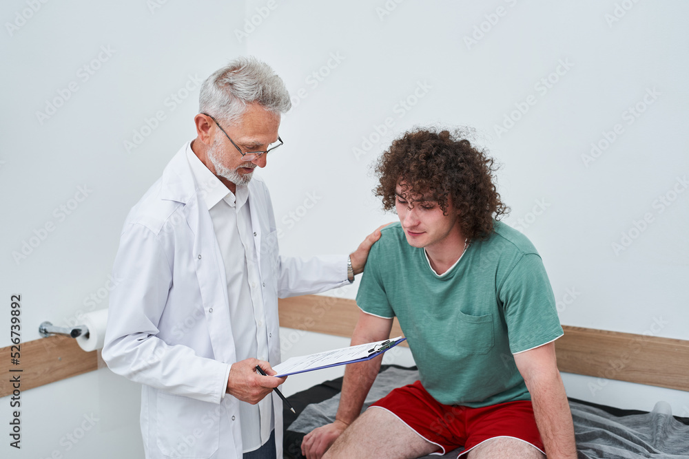 Fototapeta premium Mature rehabilitation physiotherapy man at work with male client