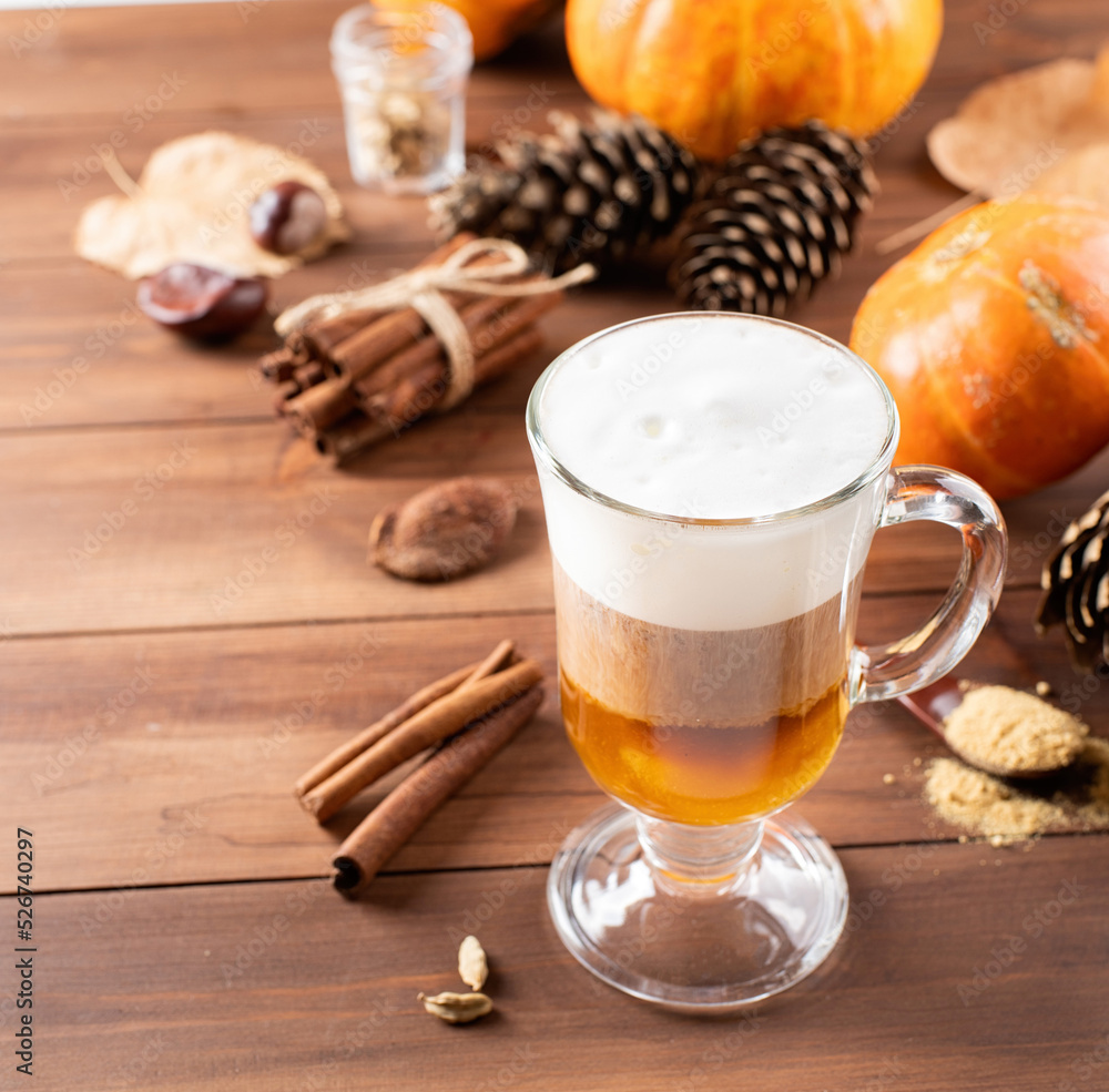 Pumpkin spice latte in a glass mug with cinnamon and ginger Pumpkin spice latte in a glass mug with cinnamon and ginger