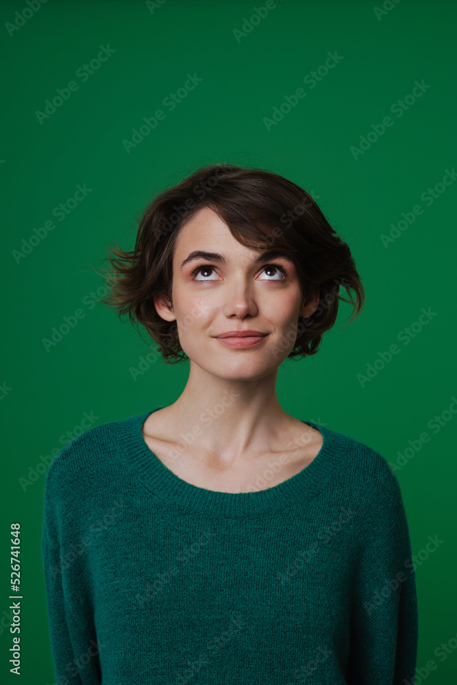 Young white woman wearing sweater posing and looking upward Young white woman wearing sweater posing and looking upward