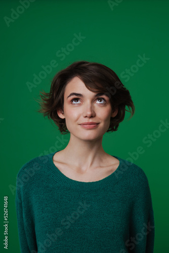 Young white woman wearing sweater posing and looking upward