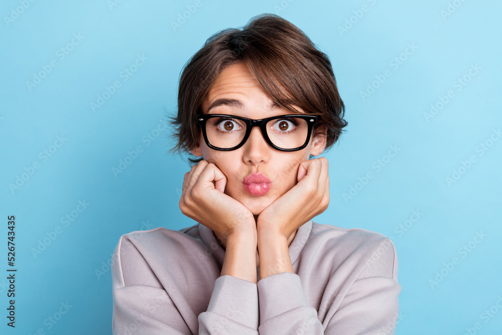 Photo of pretty sweety cute gentle lady arm touch cheekbones send kiss nice eyewear stylish outfit isolated on blue color background