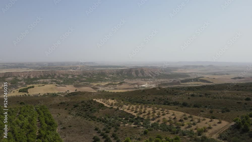 Panoramic aerial drone shot of dry mountain scenery as panning left showing green forest in the foreground. Panoramic aerial drone shot of dry mountain scenery as panning left showing green forest in the foreground.