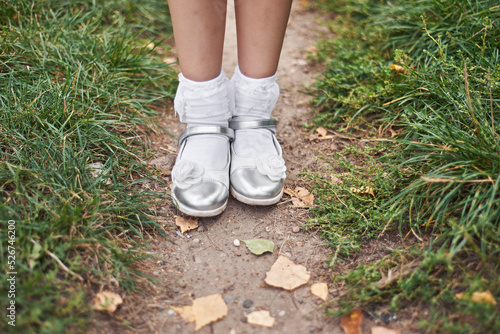 little girl's legs with shoes and white socks.