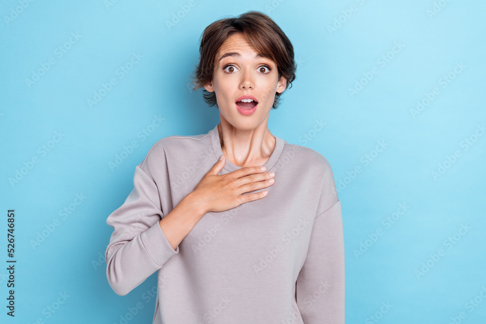 Photo of impressed lady arm touch breast dont believe success achieve ask serious really me open mouth isolated on blue color background Photo of impressed lady arm touch breast dont believe success achieve ask serious really me open mouth isolated on blue color background