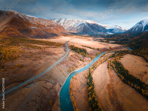 Blue river with yellow autumn trees in the mountains. Chuya river and Chuisky tract in Altai, Russia.