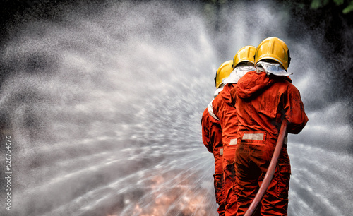 In Industry safety fire fighter team department on  training fight with gas and oil fire by hold hose together spray jet turbulence water and foam to extinguish remove oxygen
 photo