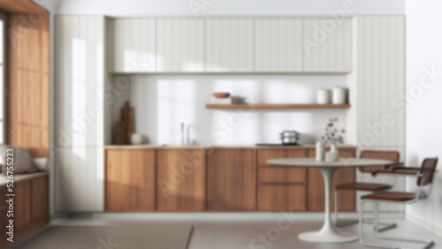 Blurred background, japandi trendy wooden kitchen and dining room. Wooden cabinets, contemporary wallpaper and big window. Minimalist interior design