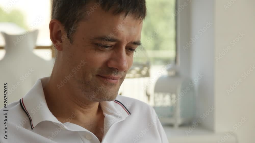 A man is intently reading a book and smiling, close-up. A man is intently reading a book and smiling, close-up.